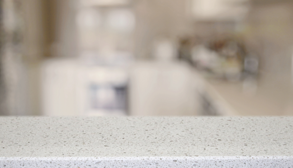 White quartz countertop with small gray speckles.