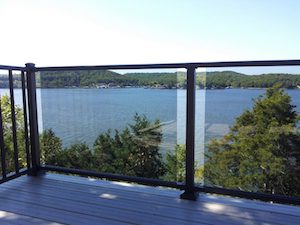 Tempered Glass Westbury Veranda Series railing on an upper deck with lake view in background.