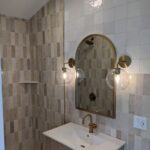 Bathroom with gold light fixtures