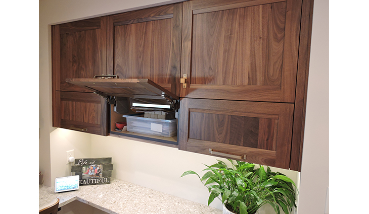 Dark wood kitchen cabinets with a white sink countertop