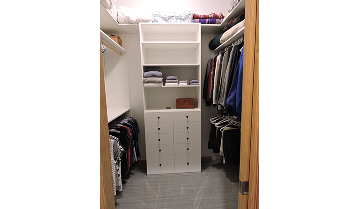 Walk-in closet with open shelves and clothing rods