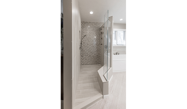 Large renovated shower in a new bathroom with a white tile floor