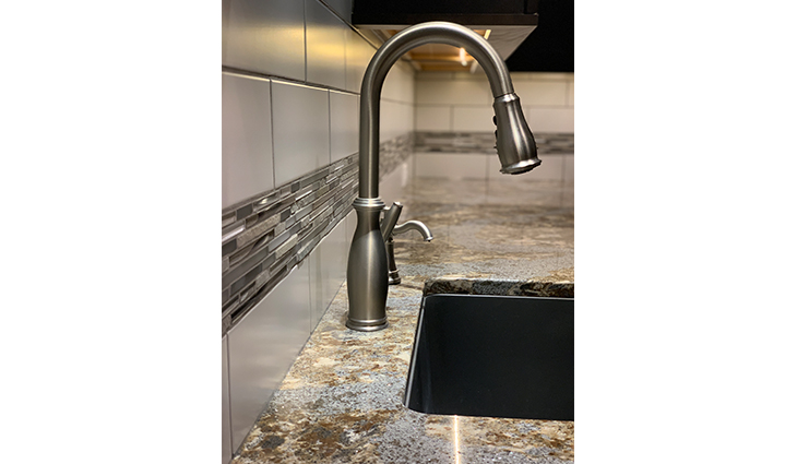 Close up on a metallic kitchen faucet