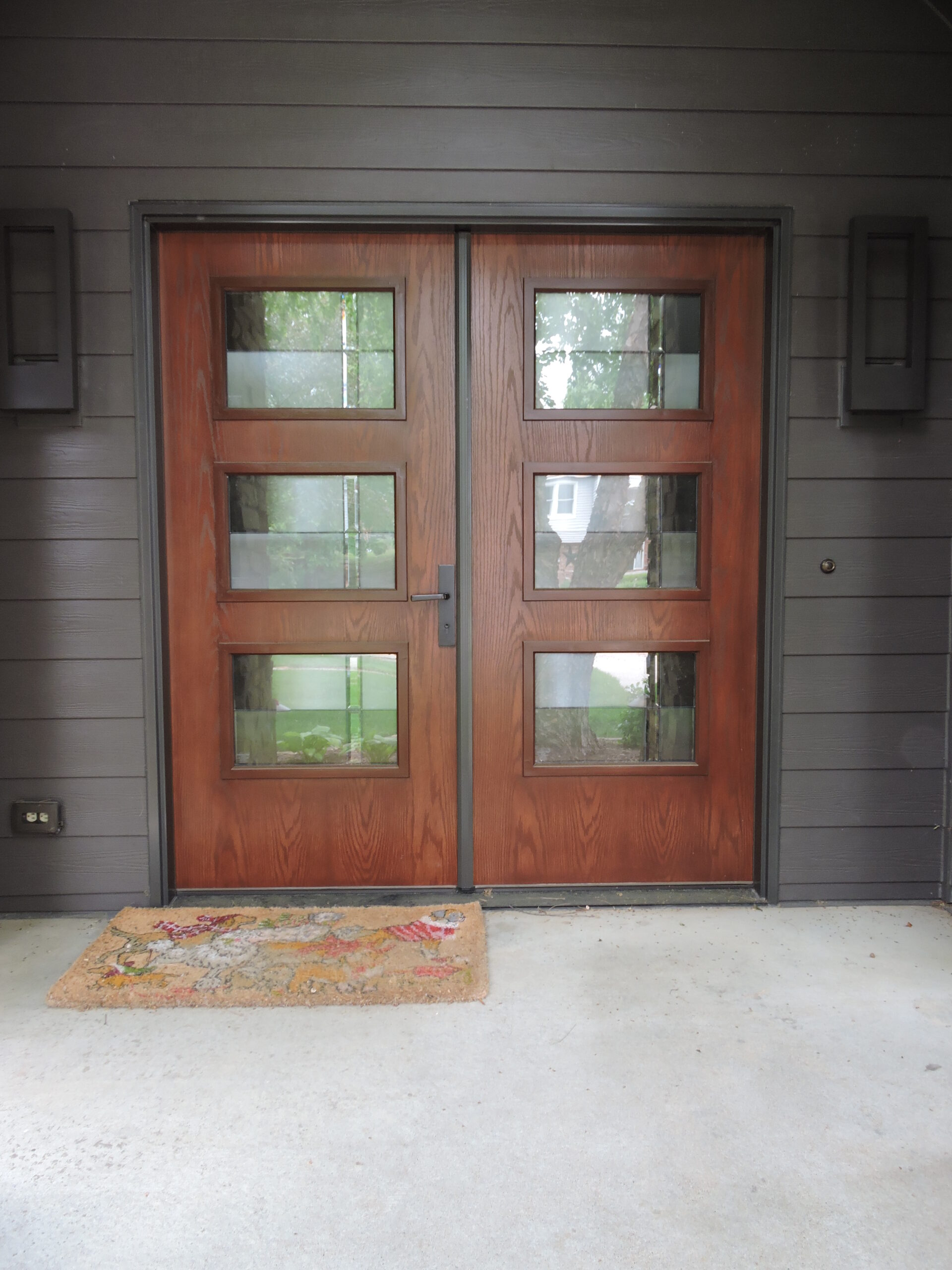 Exterior front door with dark wood and windows