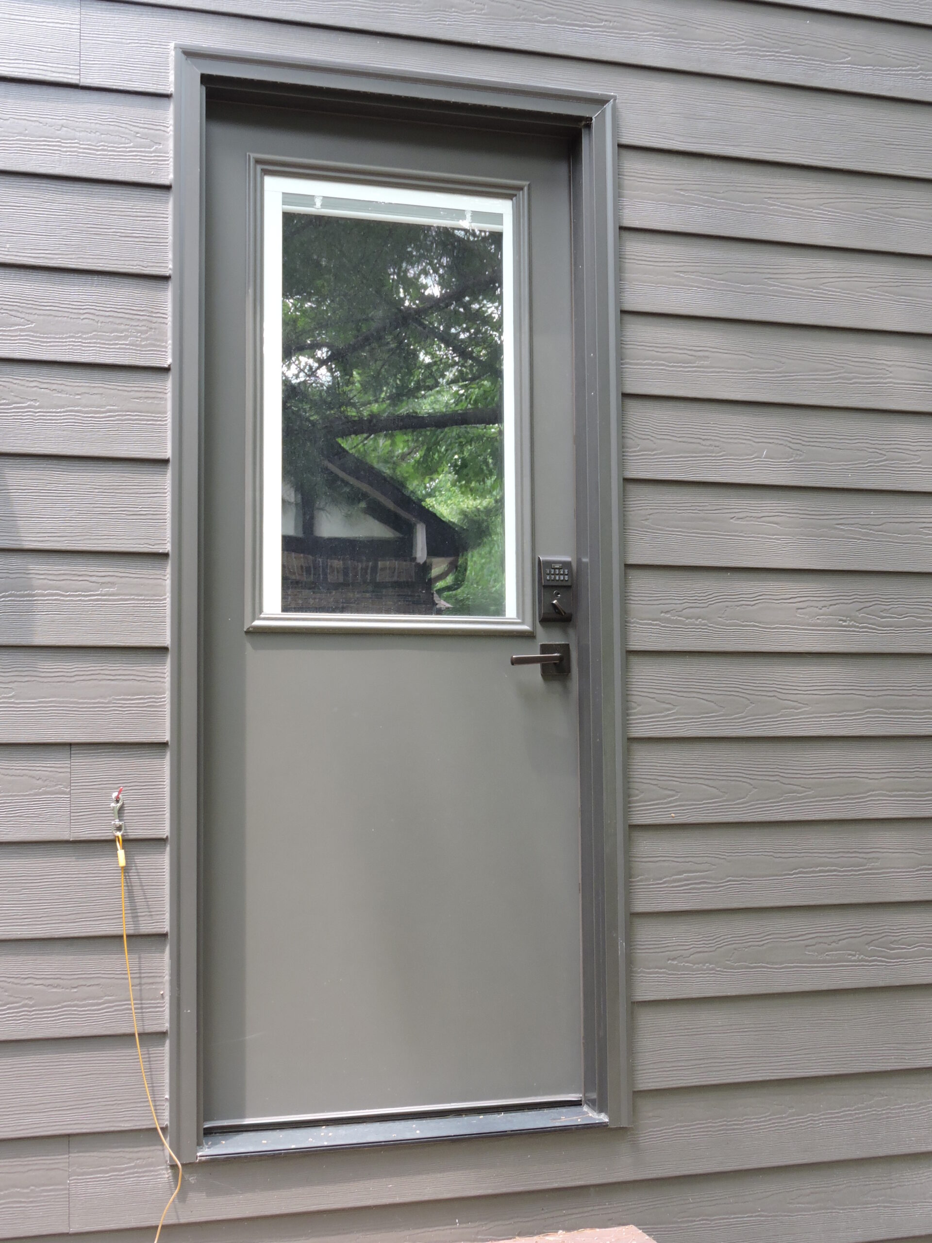 Gray exterior door with a large window