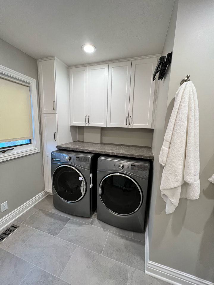 Laundry room addition with white cabients and gray walls