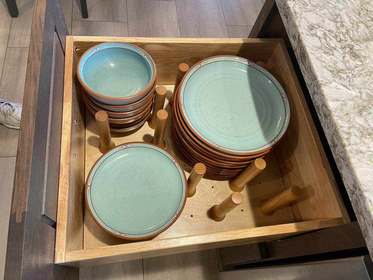 blue plates in a pulled out kitchen drawer