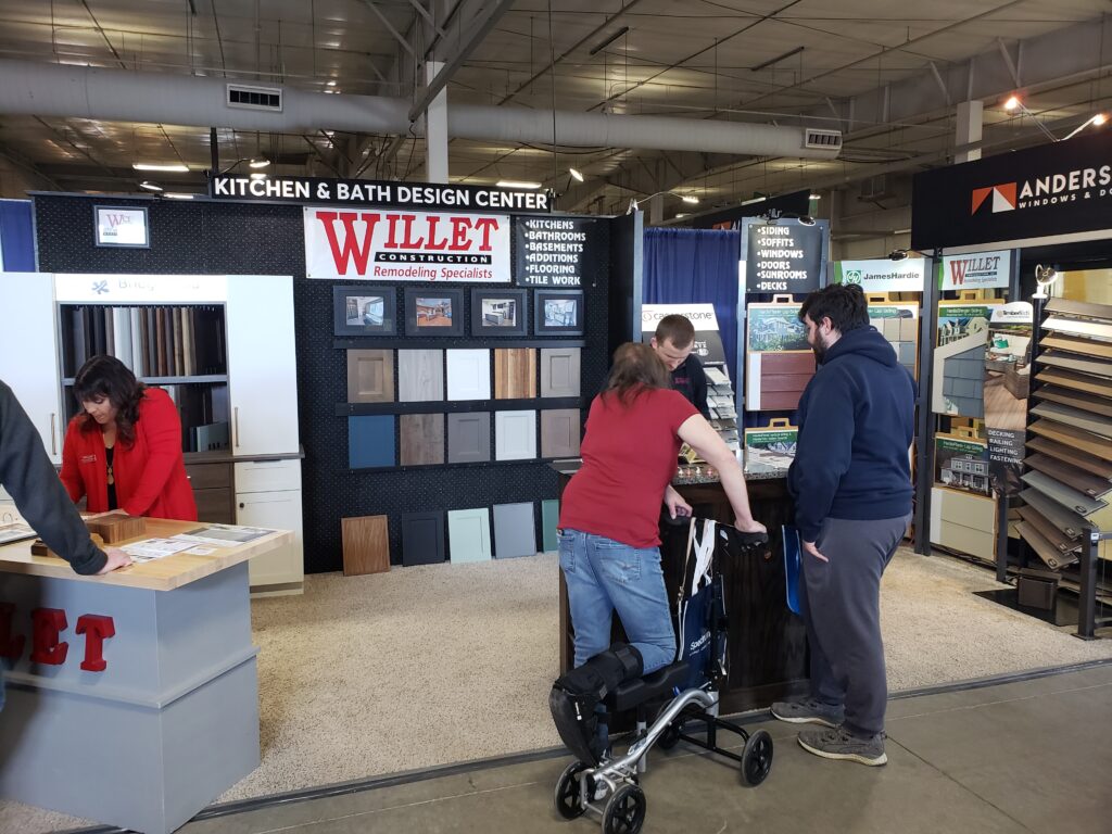 People checking out the Willet Construction booth at a trade show.