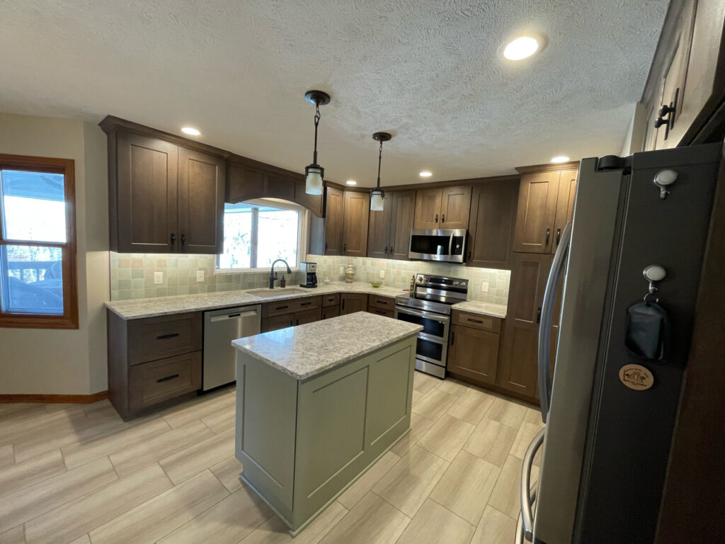 Remodeled kitchen with dark cabinetry and light countertops