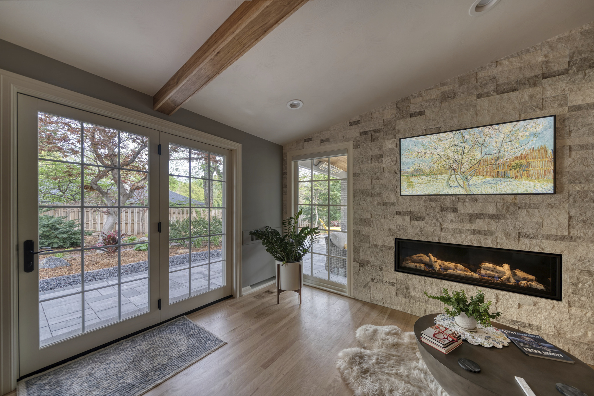 Home addition with large scenic windows, brick wall, and fireplace