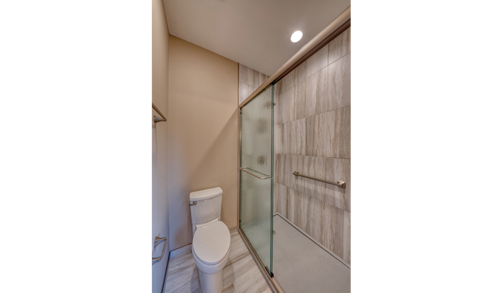 Bathroom with a toilet and shower with a sliding door