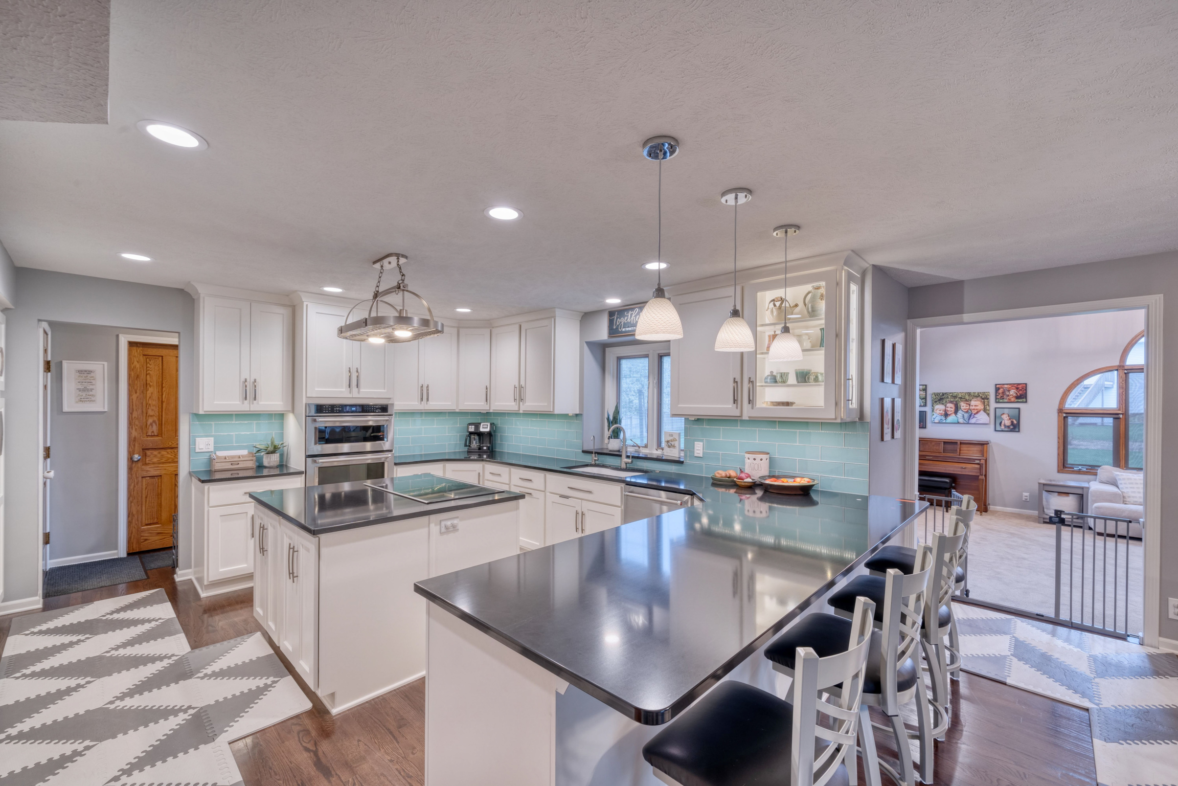 Kitchen with white cabinets and blue tile backsplash