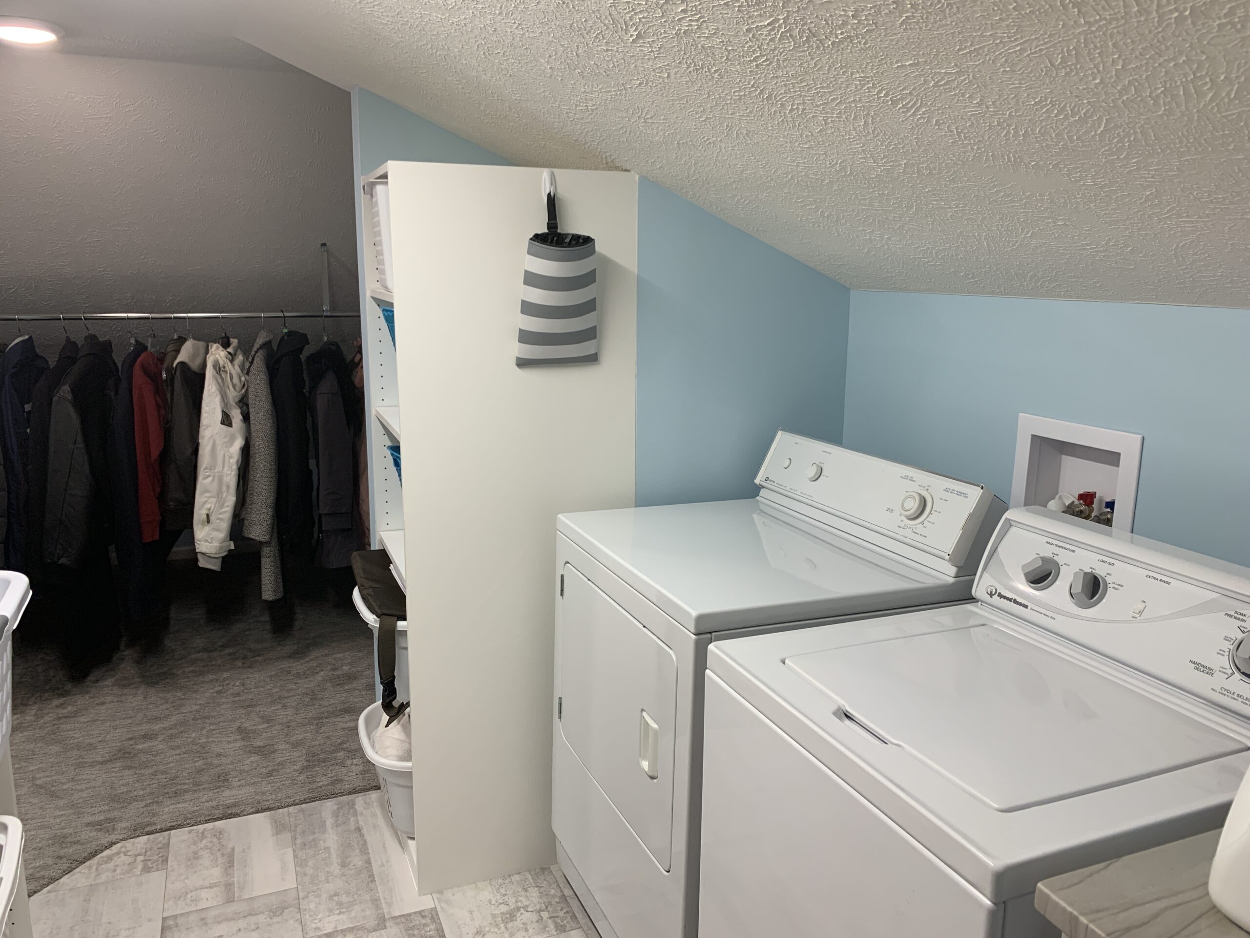 a laundry room with a slanted ceiling