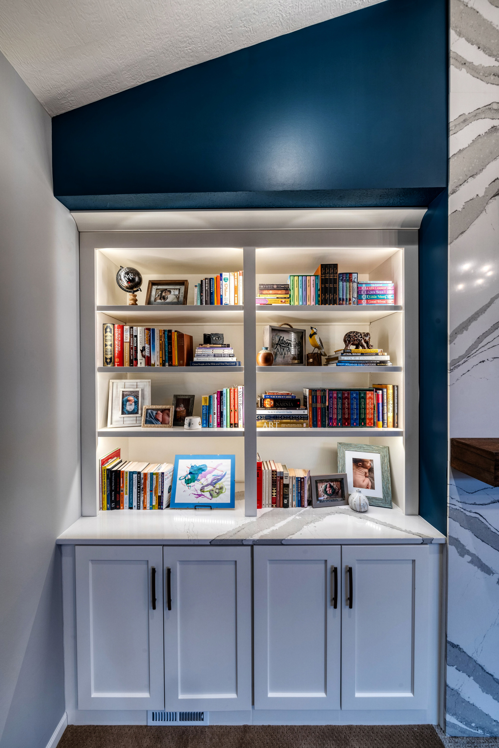 A built-in bookcase with blue paint