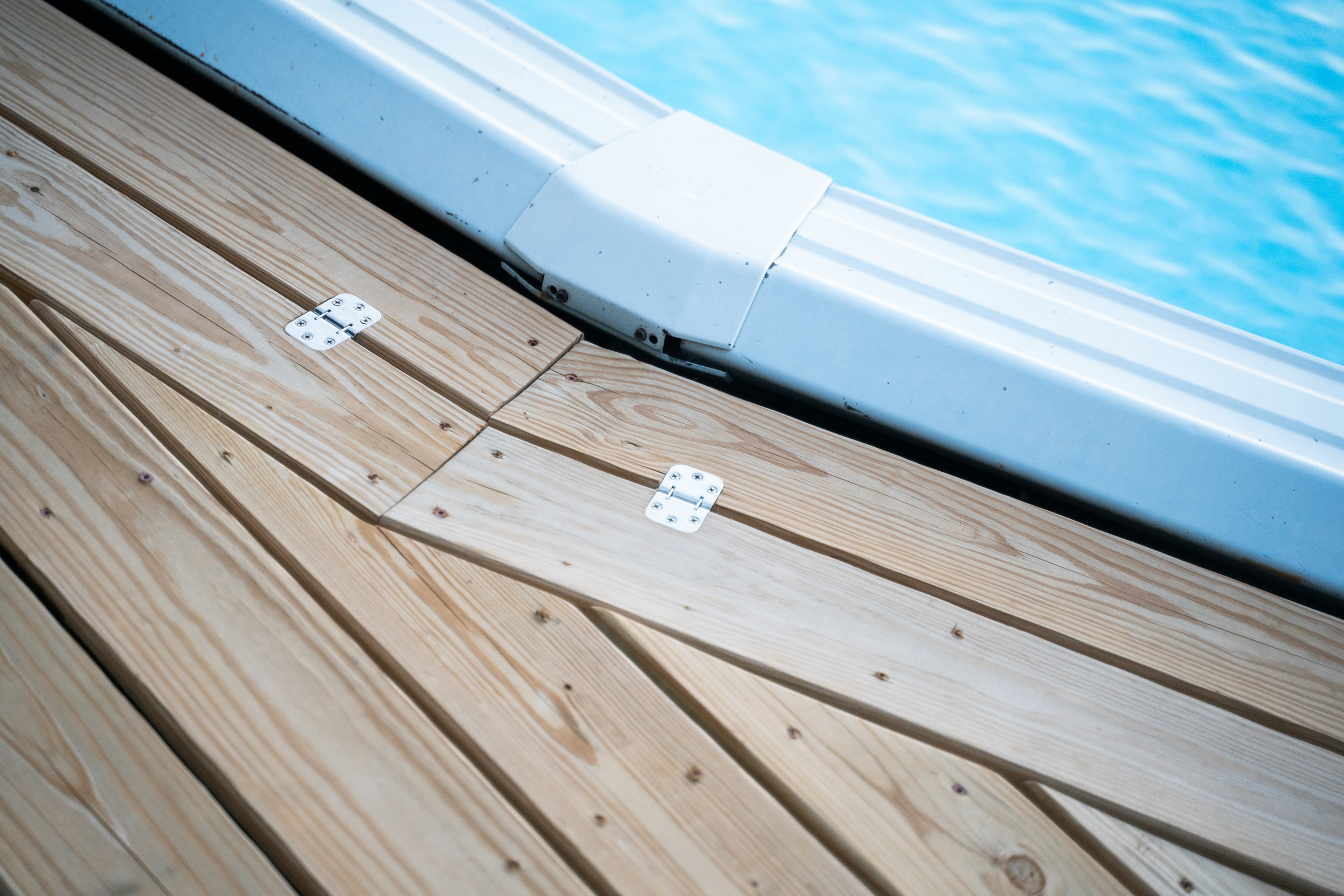 Closeup on the wood flooring next to a pool