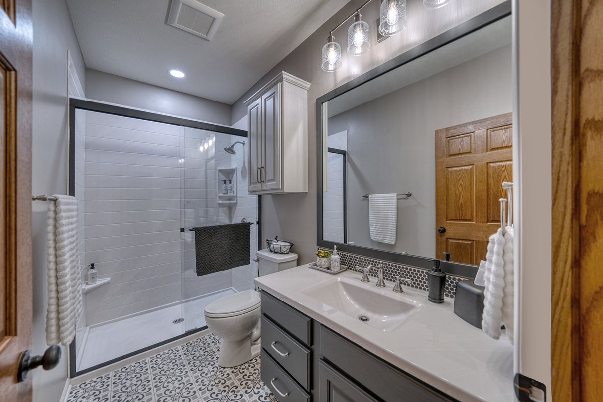 Bathroom renovation with a walk-in glass shower and pattern tile floors