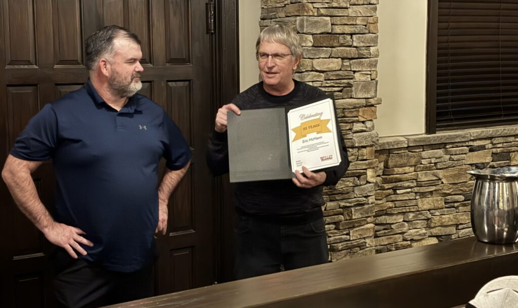 Eric receiving a certificate of acknowledgement for 25 years with Willet.
