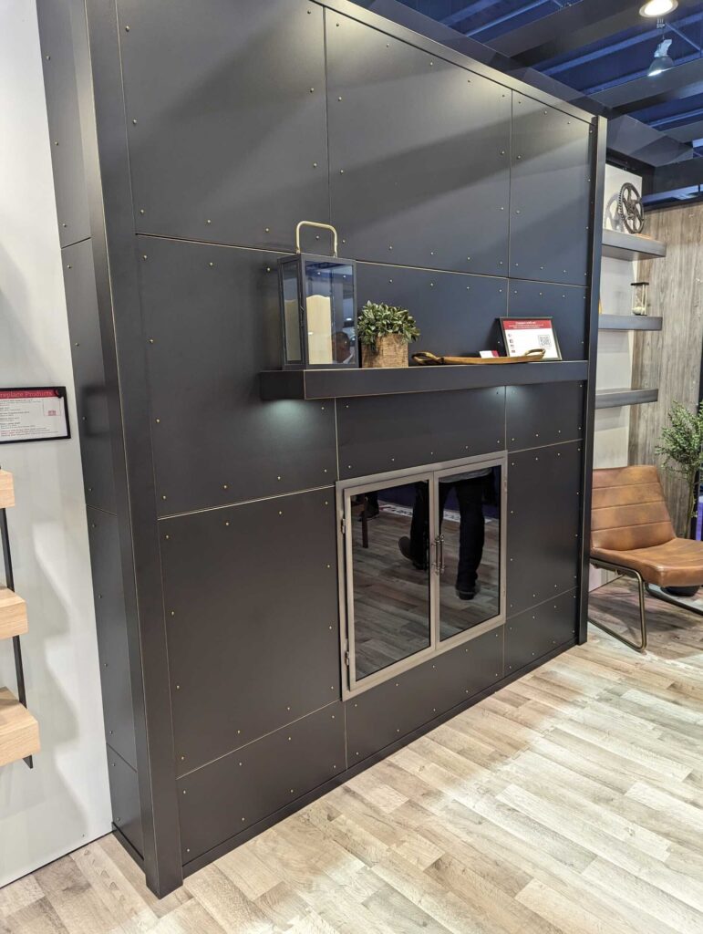 An industrial-look fireplace surrounded by dark gray industrial-looking panels.