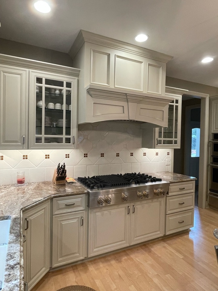 After image of kitchen with updated stove and range hood.
