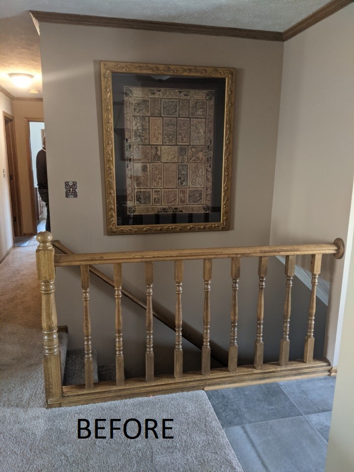"Before" image of outdated woodgrain stair railing at the top of a staircase.