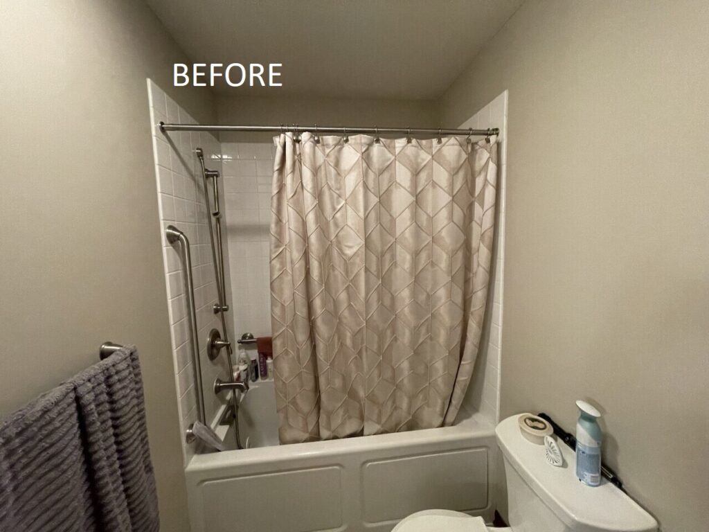 "Before" image of a regular bathtub/shower combo with tan shower curtain and light tan walls.