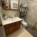 Before image of small outdated bathroom.