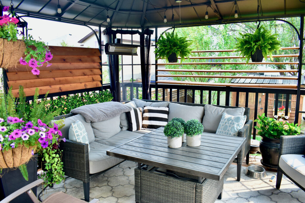 Beautiful seasonal outdoor living room with lush greenery and flowers for spring and summer