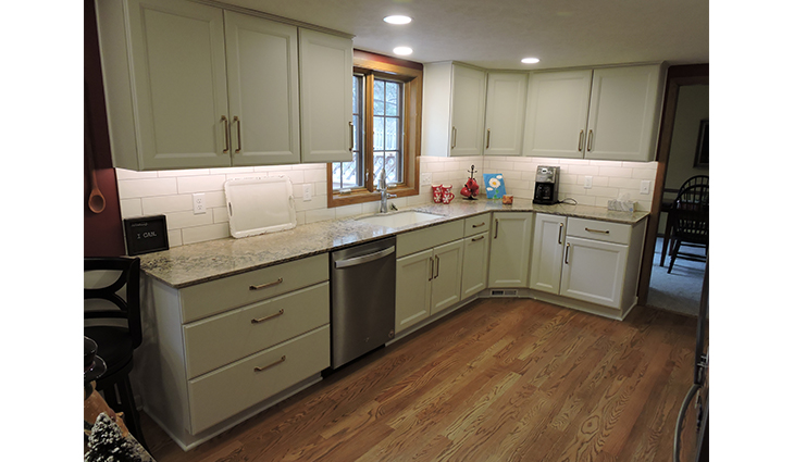 Remodeled kitchen with light green cabinets