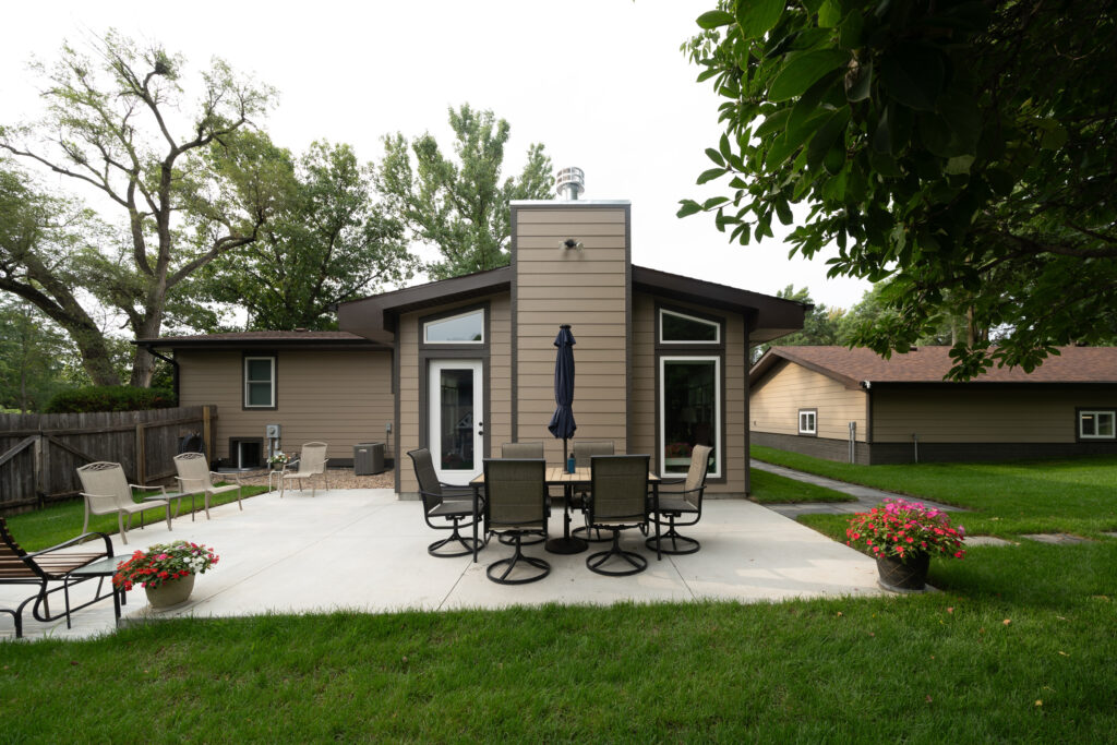 A view of a back yard patio and new home addition