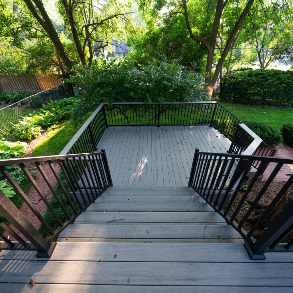 A new deck leading to a lush backyard