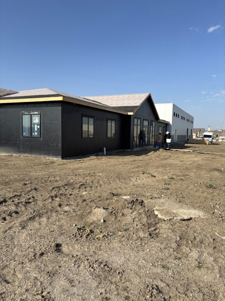 The future office of Willet Construction now has walls, windows, and a roof.