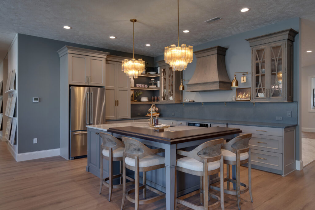 A kitchen remodel that features dark grey walls and sandalwood cabinets