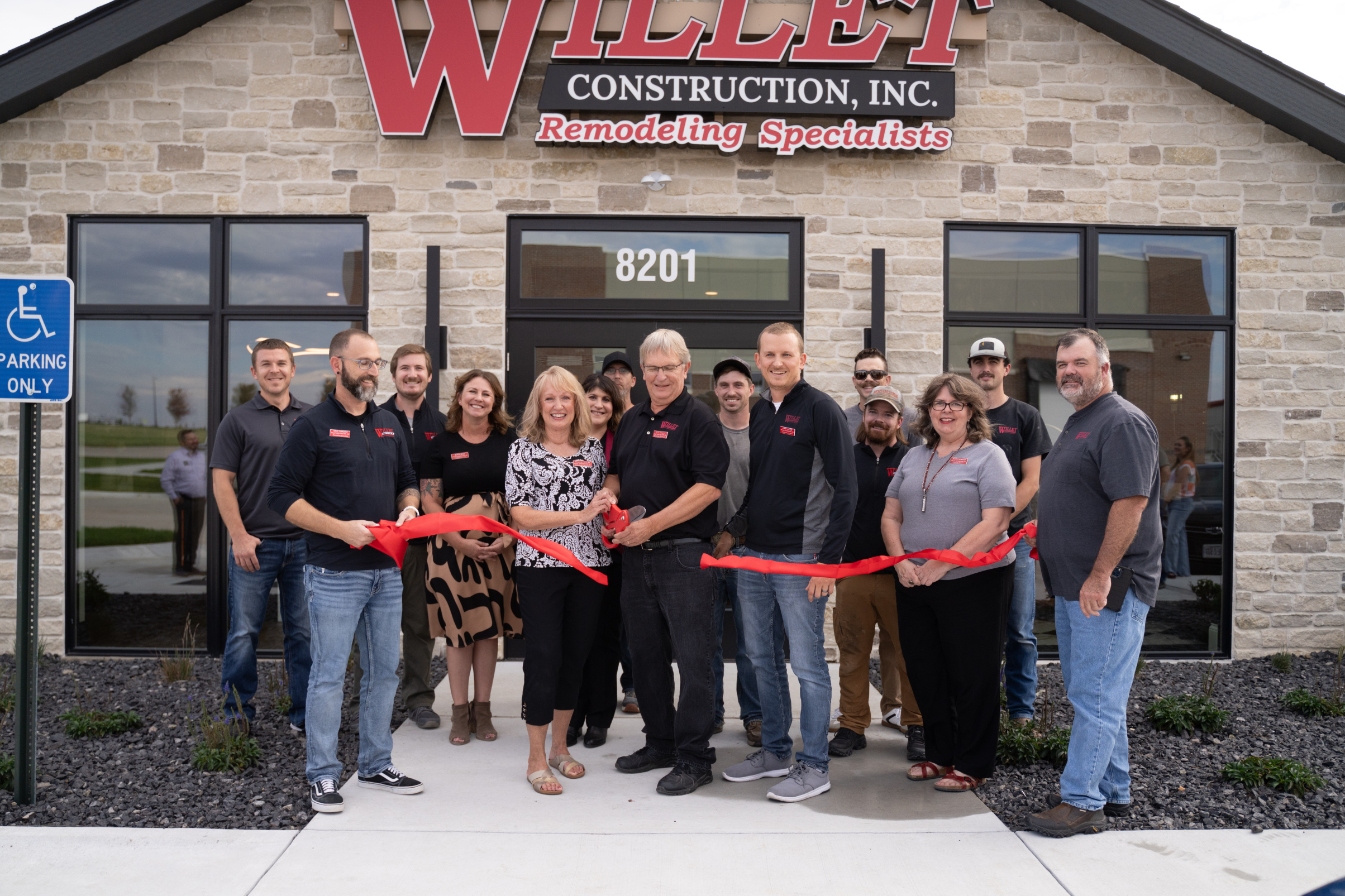 Ribbon cutting outside Willet Construction's new office